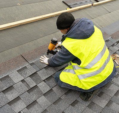 Shingles — Worker Installing Roof Shingles in Muskegon, MI