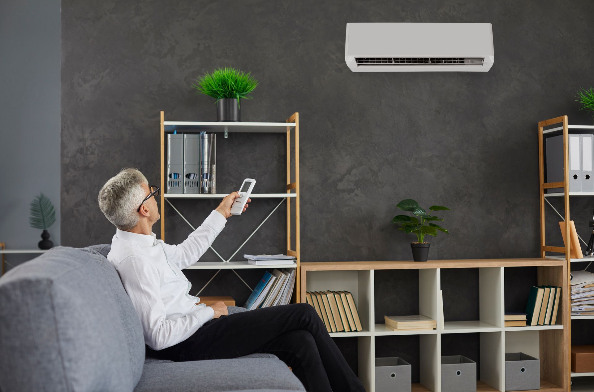 man turning on air conditioner in Youngtown, AZ