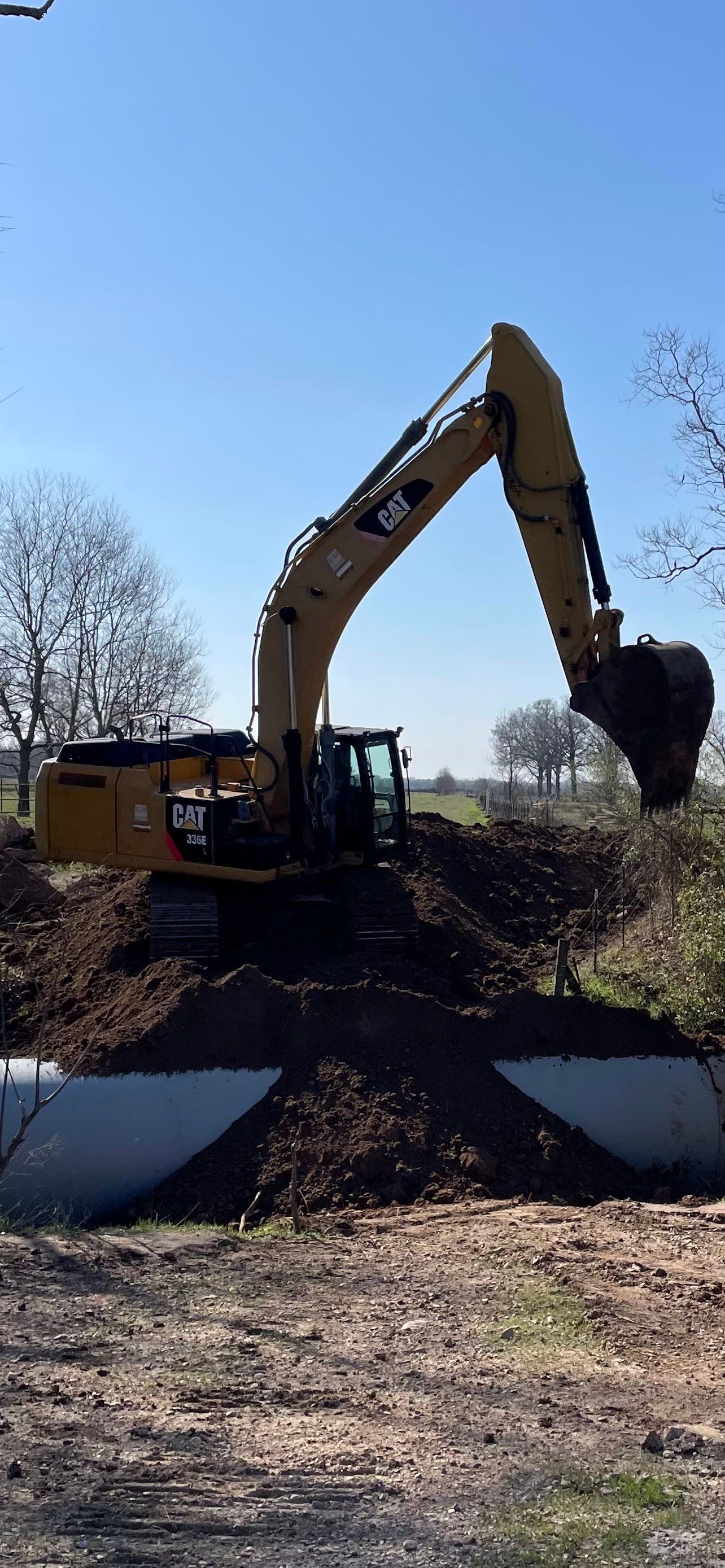 Yellow excavator digging in dirt, sunset sky. Yellow excavator digging in dirt, sunset sky.