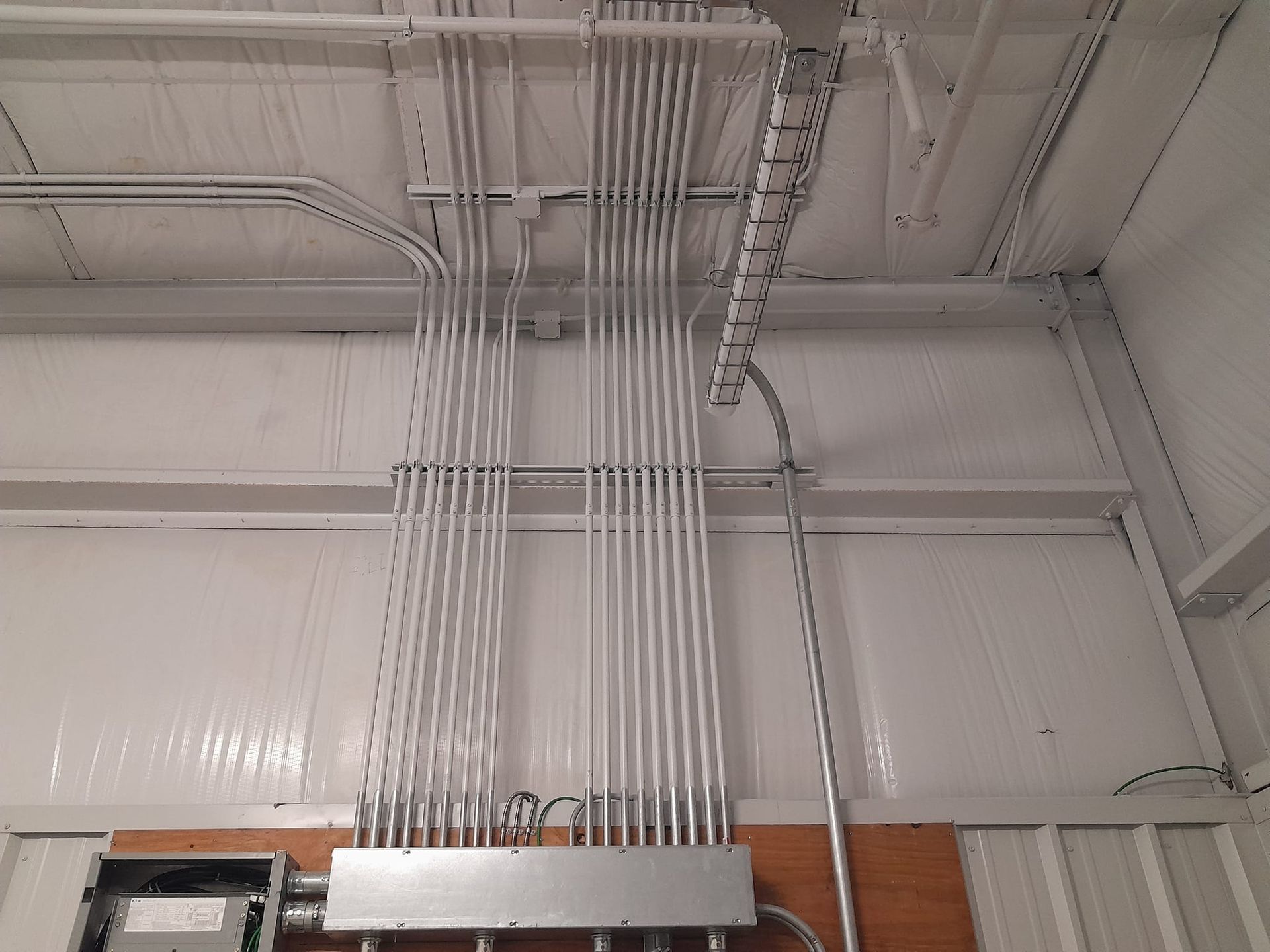 Electrical tools and wiring diagram on a white surface, including pliers, tester, and cables.