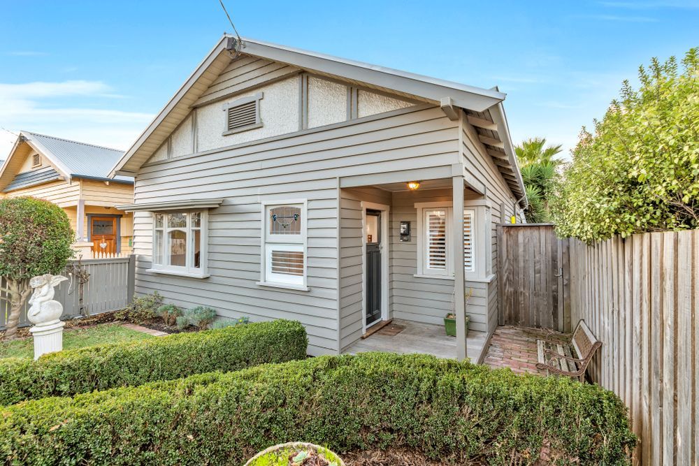 A Window With Shutters on It is on the Side of a Building — Karlene's Conveyancing In Kincumber, NSW