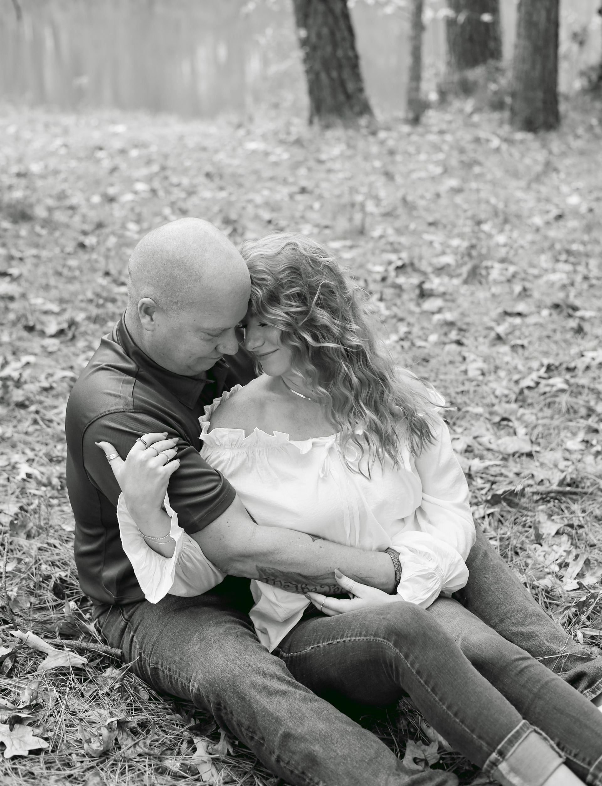 Couple embraces intimately while seated outdoors.
Lifestyle Photography by The Branded Studio Pike County Georgia