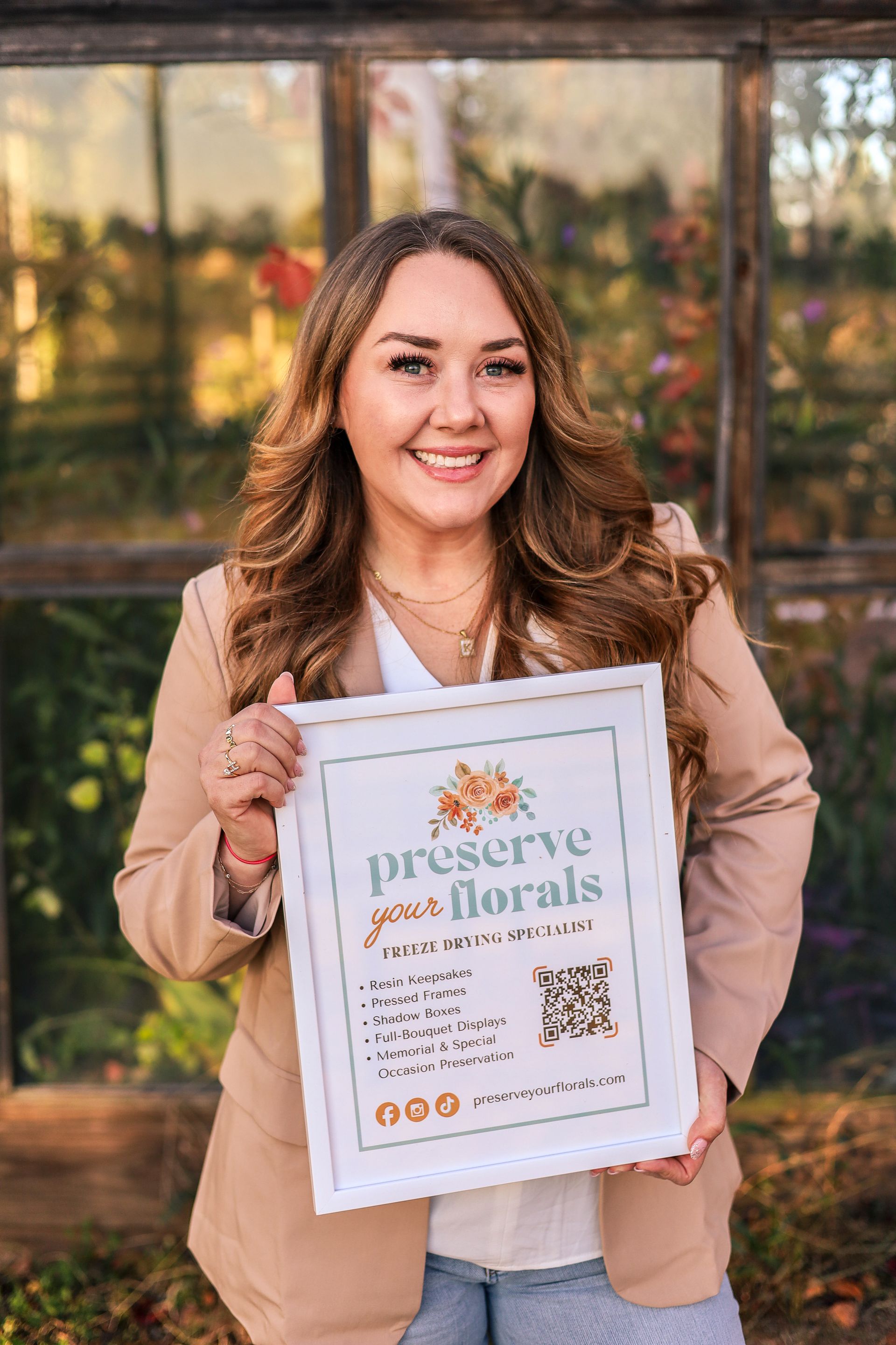 Woman holding a framed sign that says 