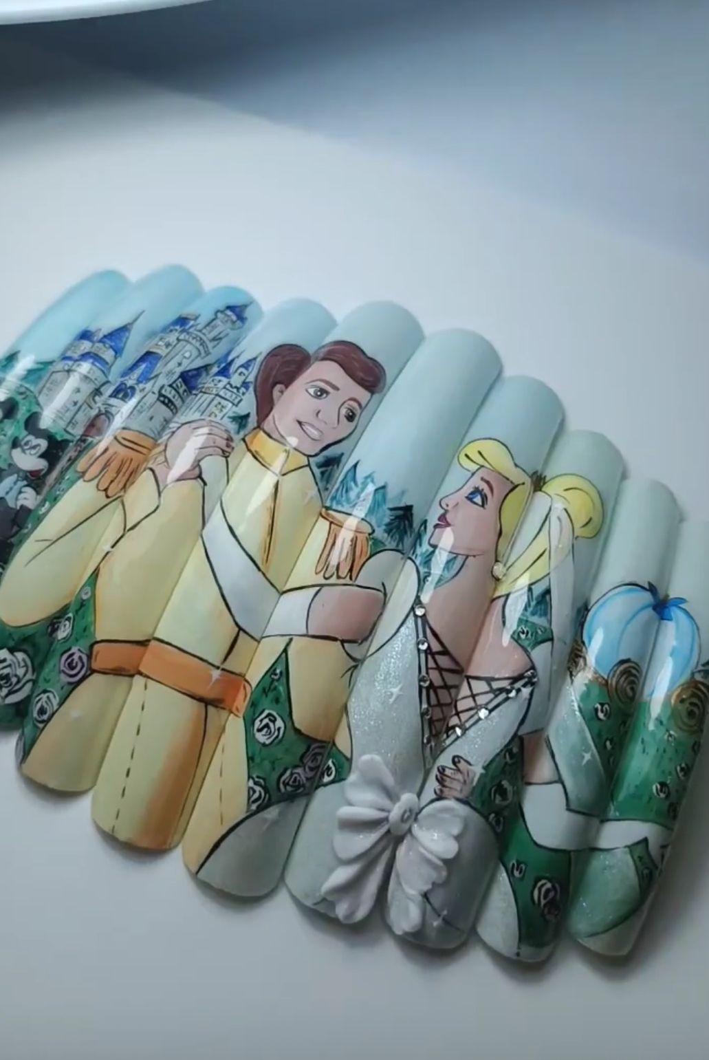 Detailed nail art featuring Cinderella and Prince Charming dancing.