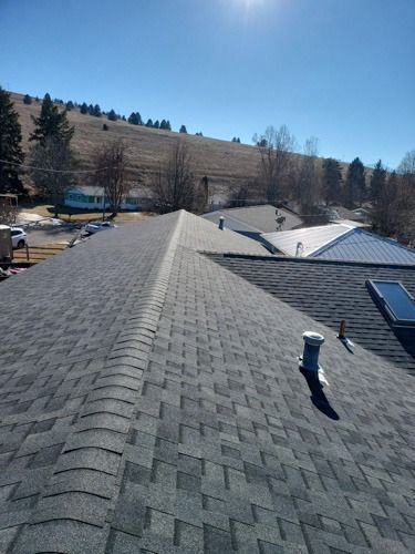 A close up of a roof with a skylight on it.