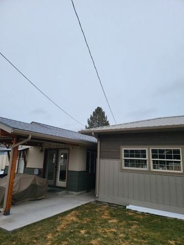 A house with a covered porch and a lot of windows.