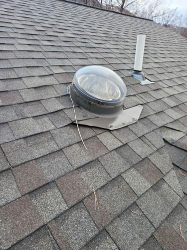 There is a skylight on the roof of a house.