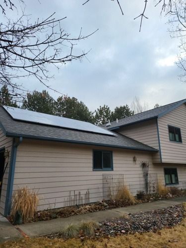 A large house with solar panels on the roof.