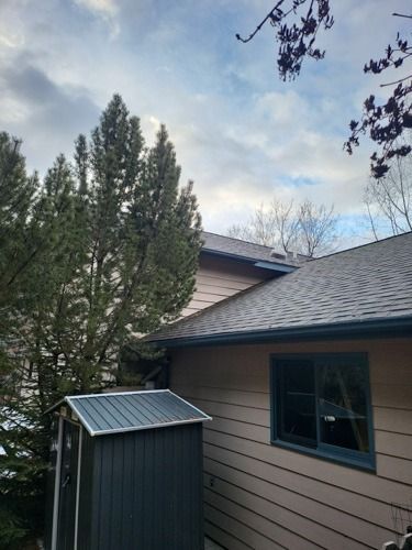 A house with a shed on the side of it.