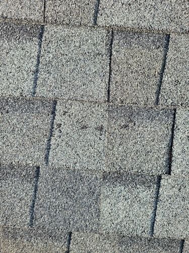 A close up of a roof with shingles on it.