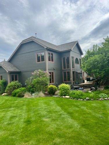A large house with a lush green lawn in front of it.