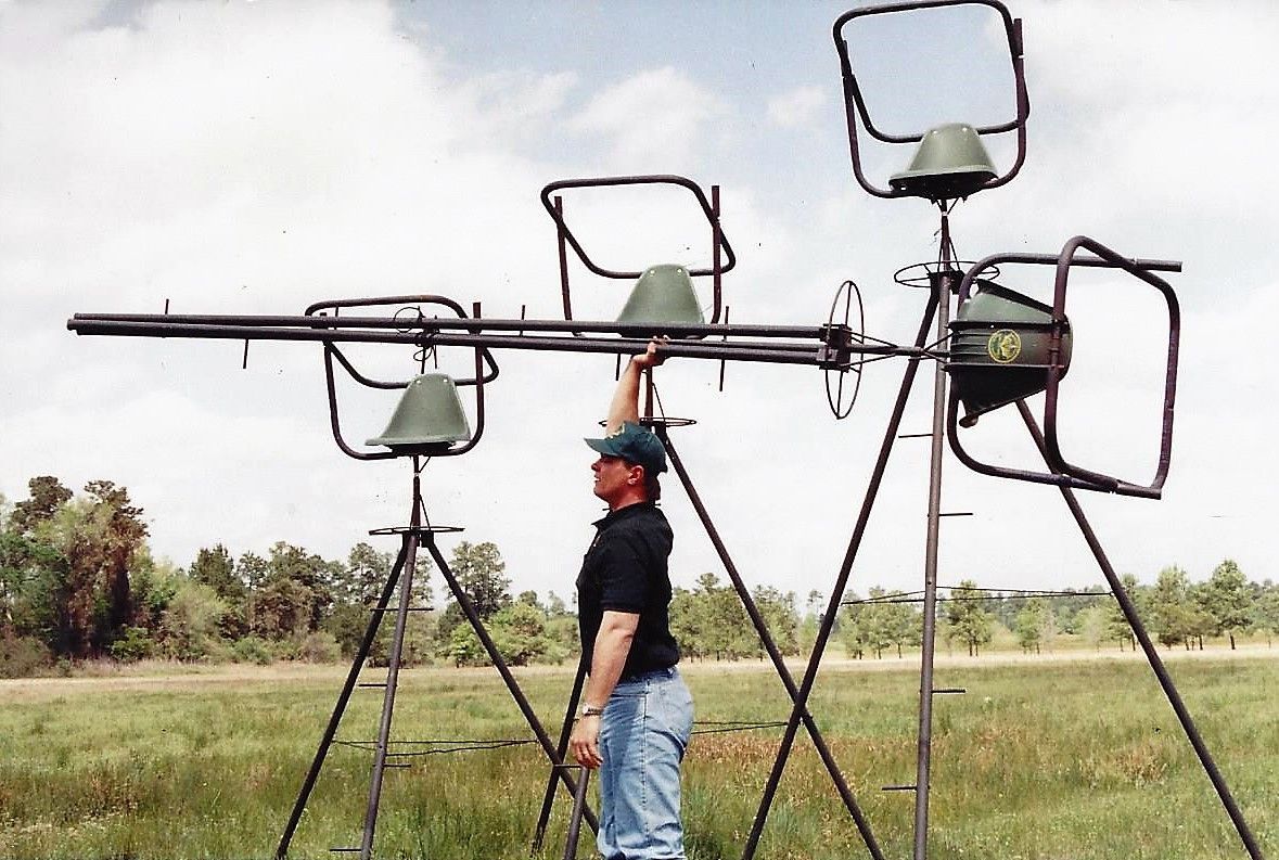 A man is standing in a field holding a large object