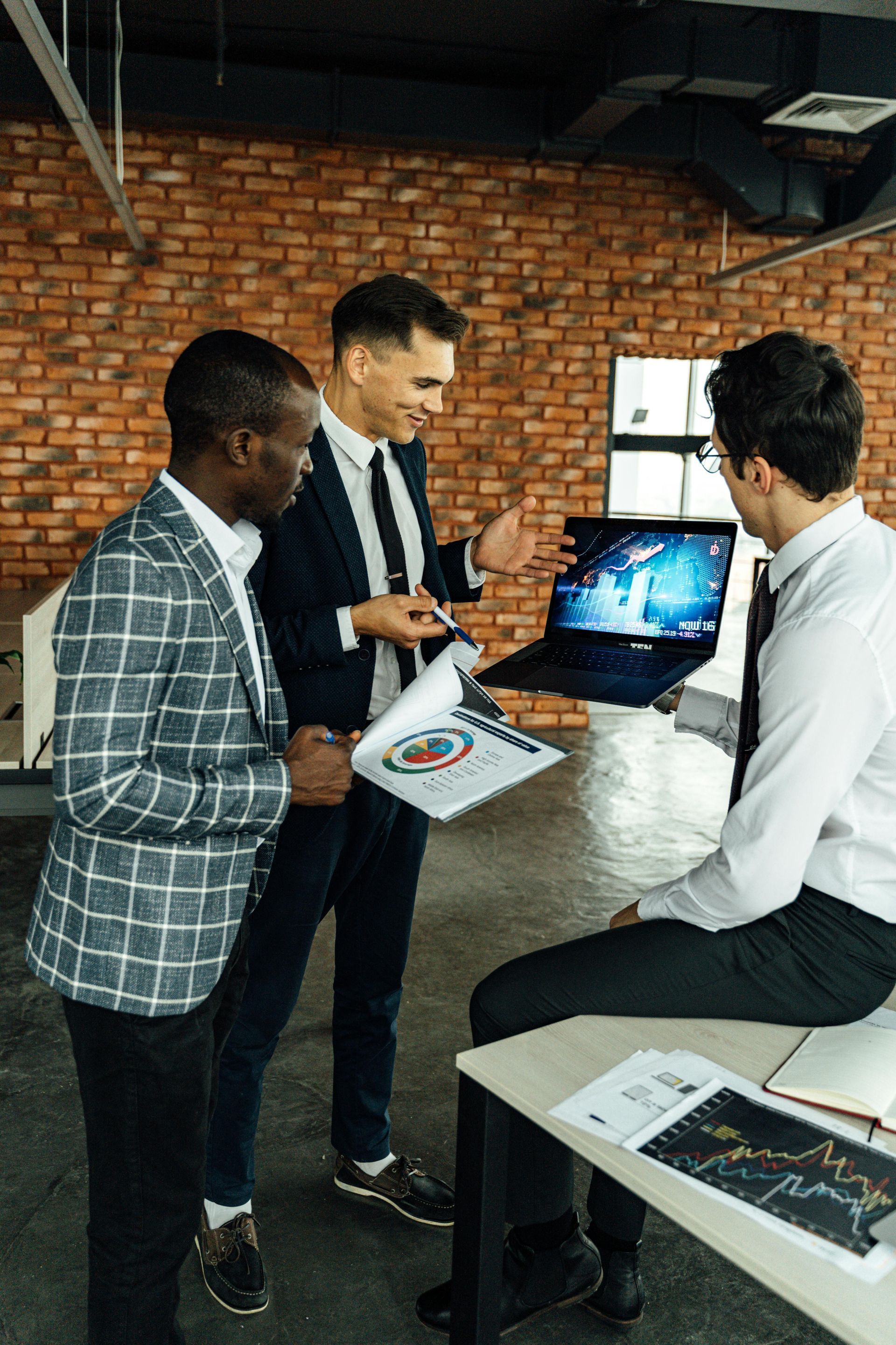 A group of men are having a meeting in an office.