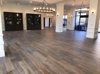 A large room with hardwood floors and a chandelier