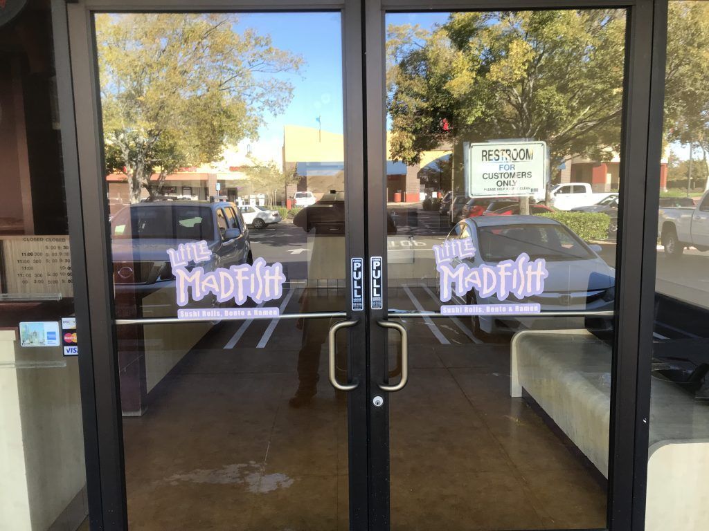 A pair of glass doors with the words we madfit on them