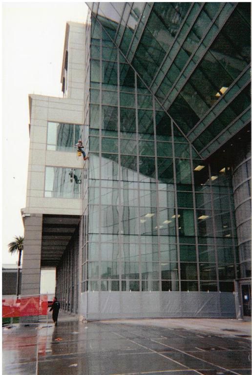 A man is climbing up the side of a building