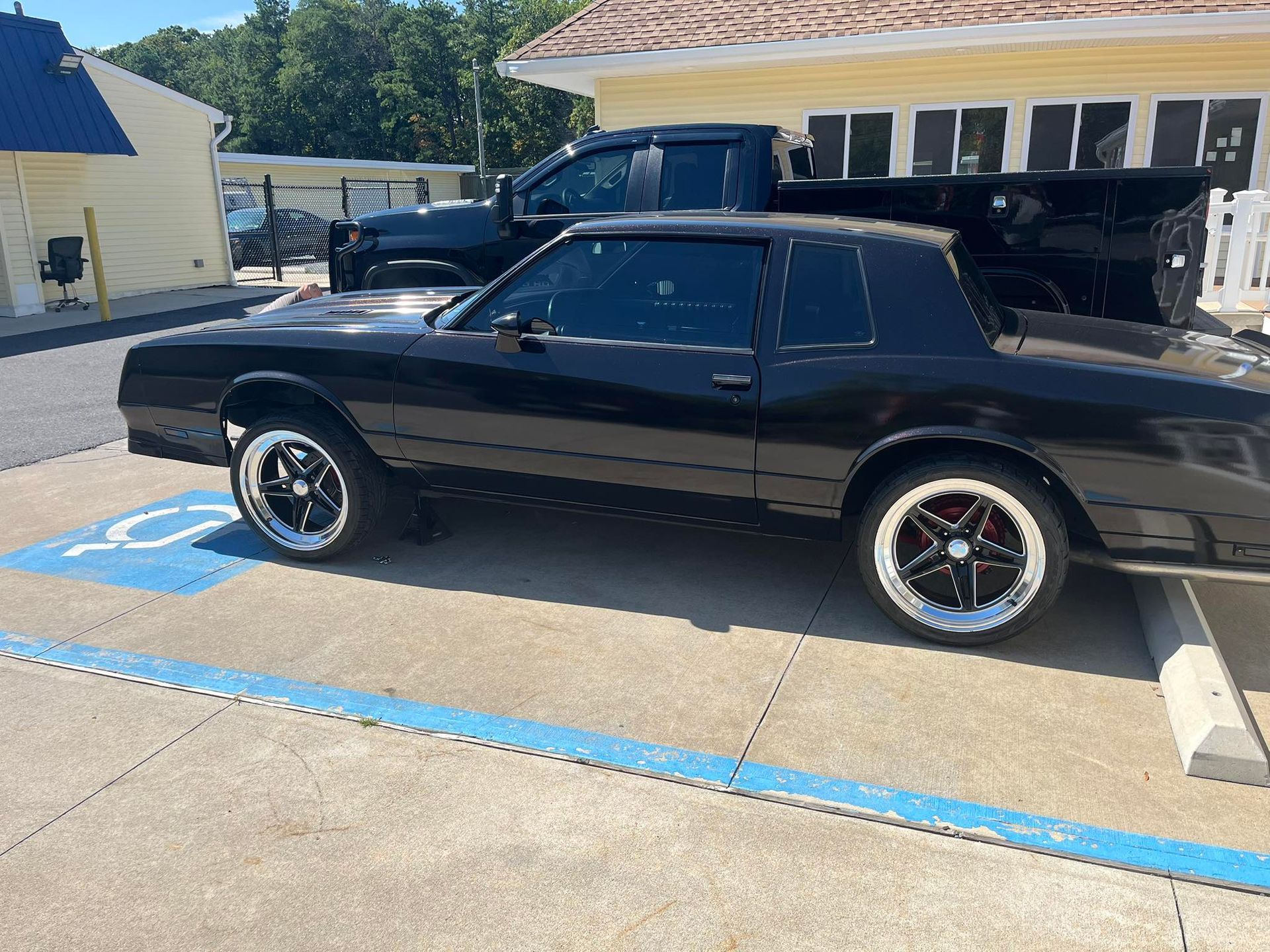 Black Buick Regal in a handicap parking space.