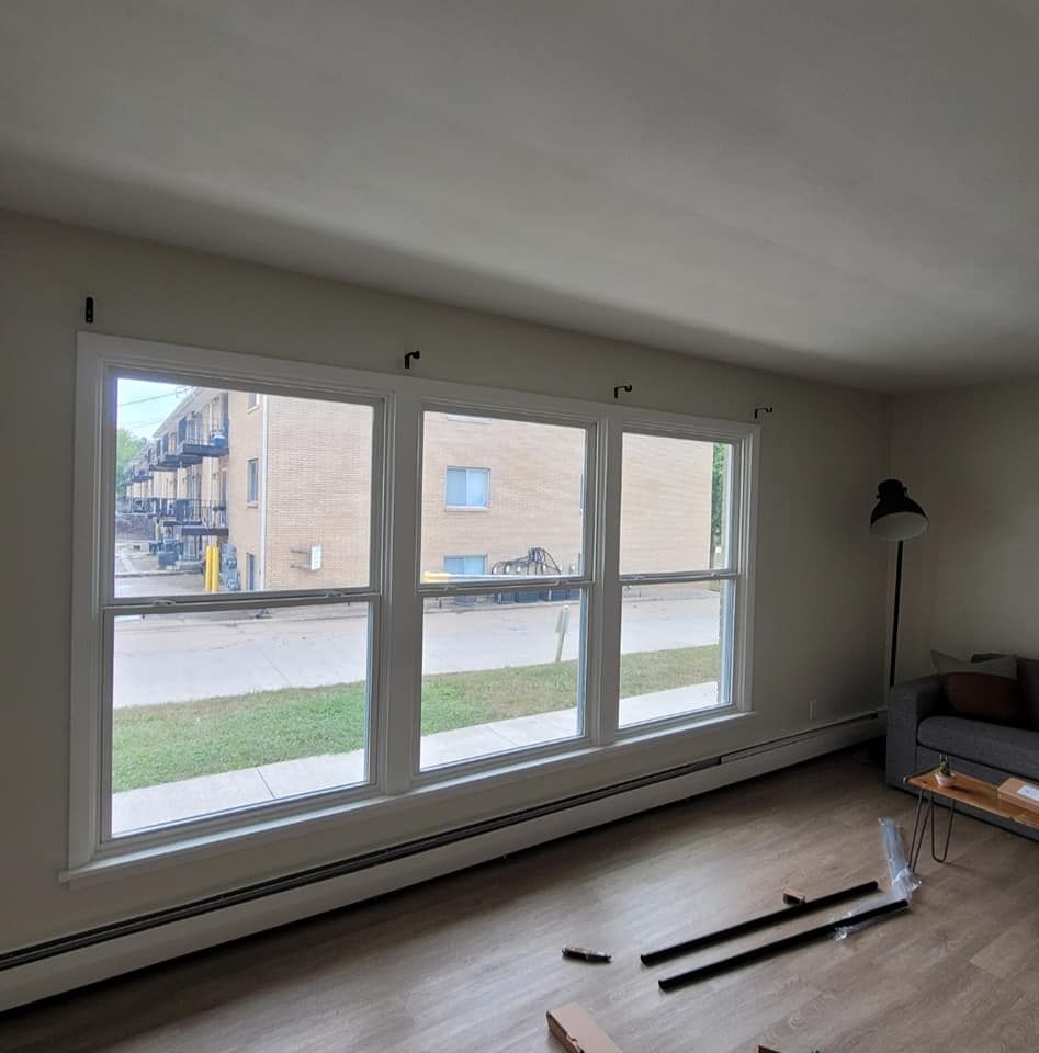 A living room with a lot of windows and a couch