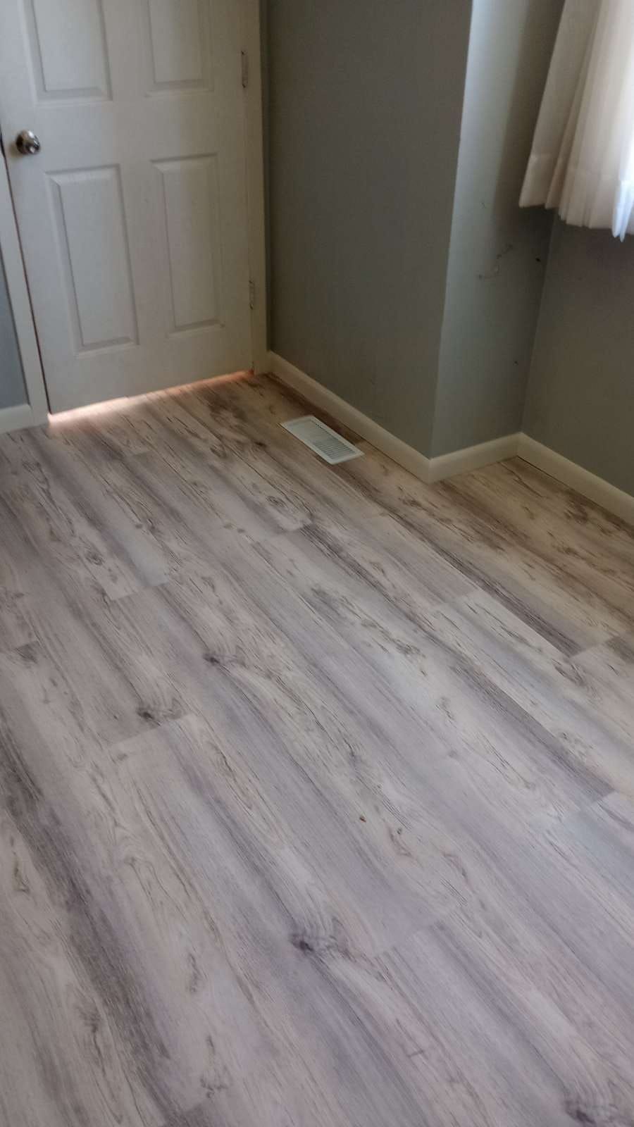 A room with a wooden floor and a door.