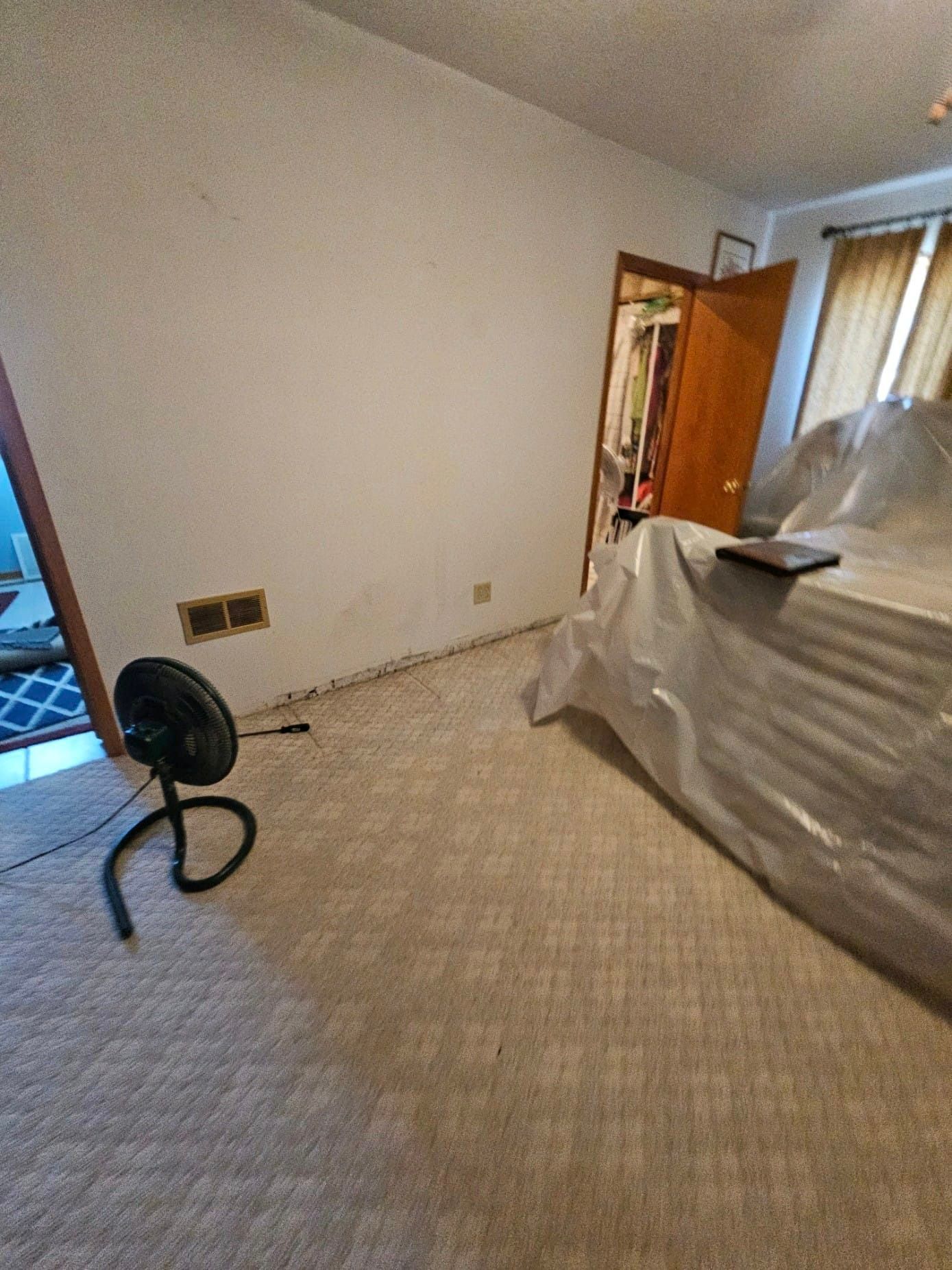 There is a fan in the middle of the room.