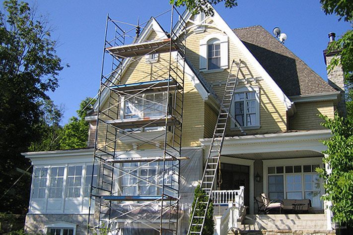 Peinture extérieure d’une maison traditionnelle avec échafaudages en place