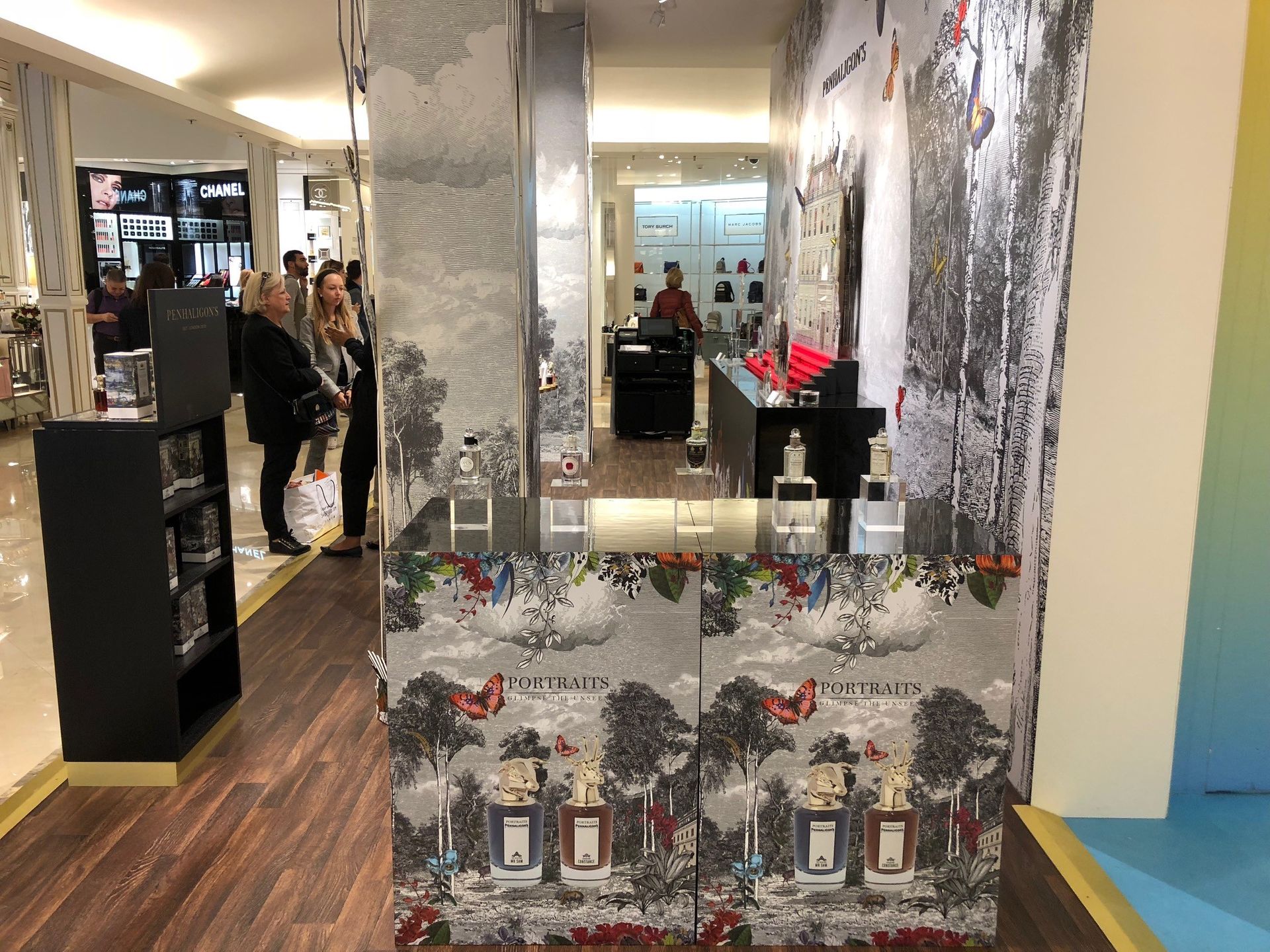 A group of people are standing in a perfume store.