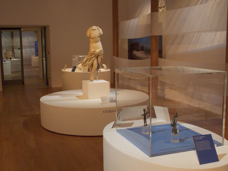 A statue of a woman is on display in a museum