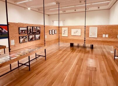 A large room with wooden floors and a table in the middle of it.