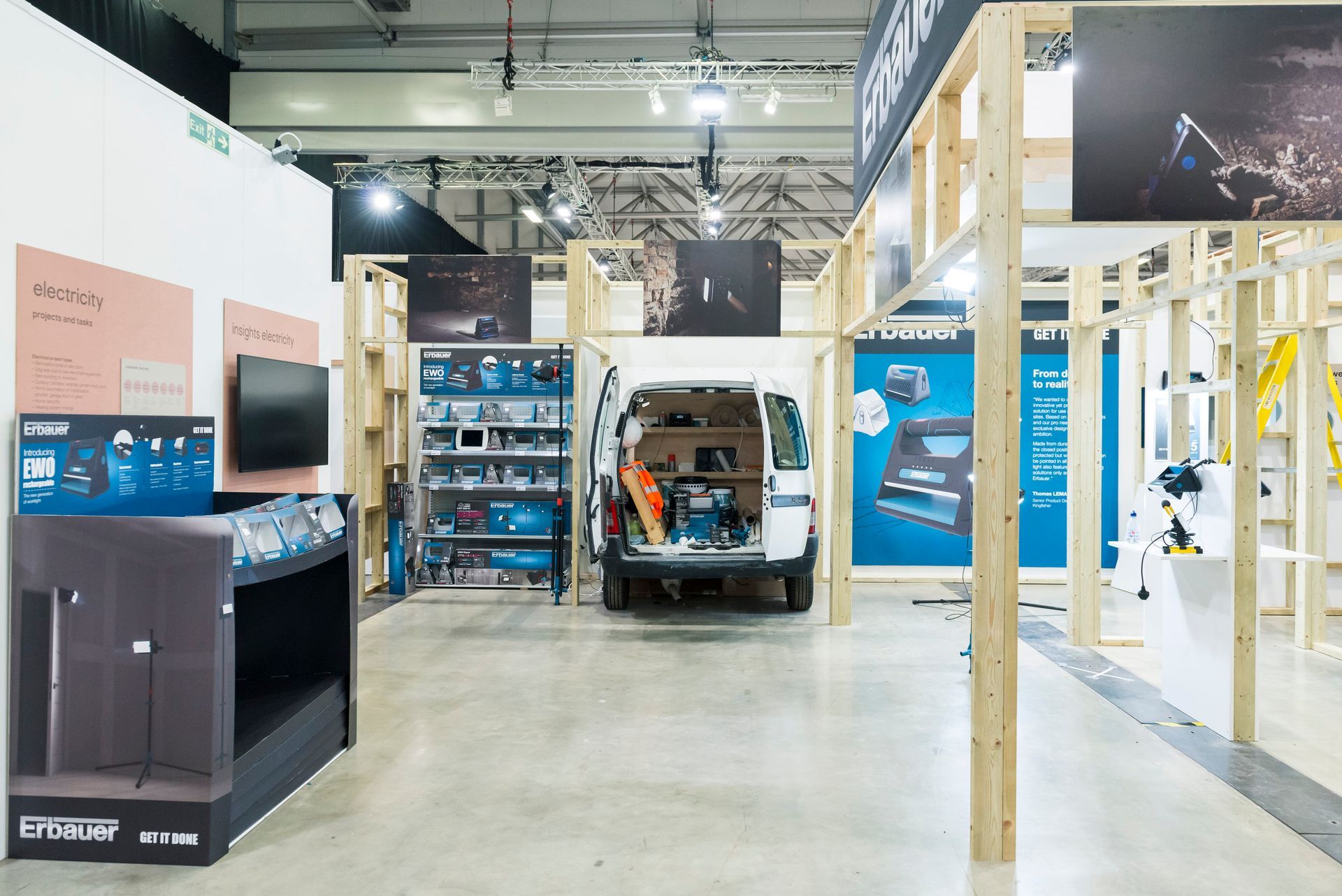 A van is parked in the middle of a large room.