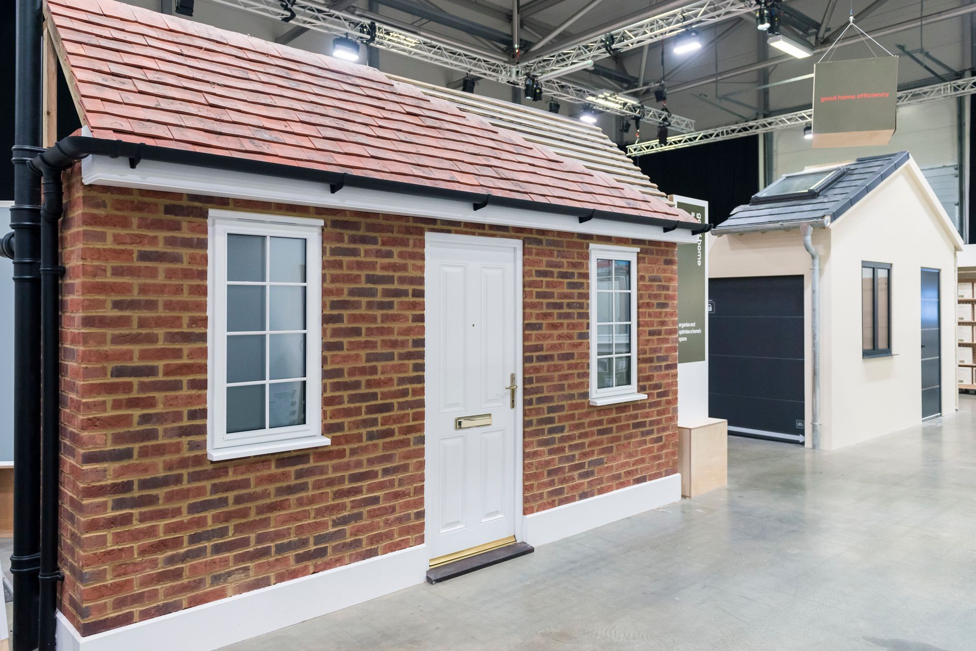 A small brick house with a white door and windows