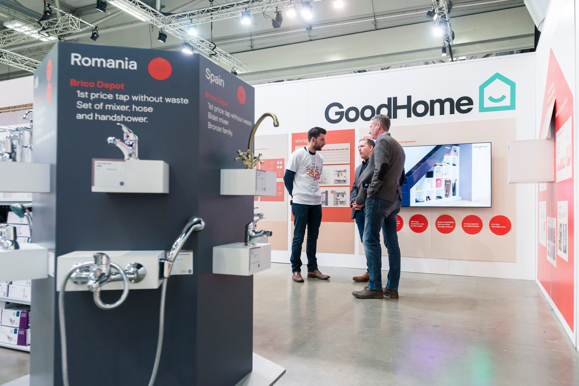 A group of people are standing in front of a good home display.