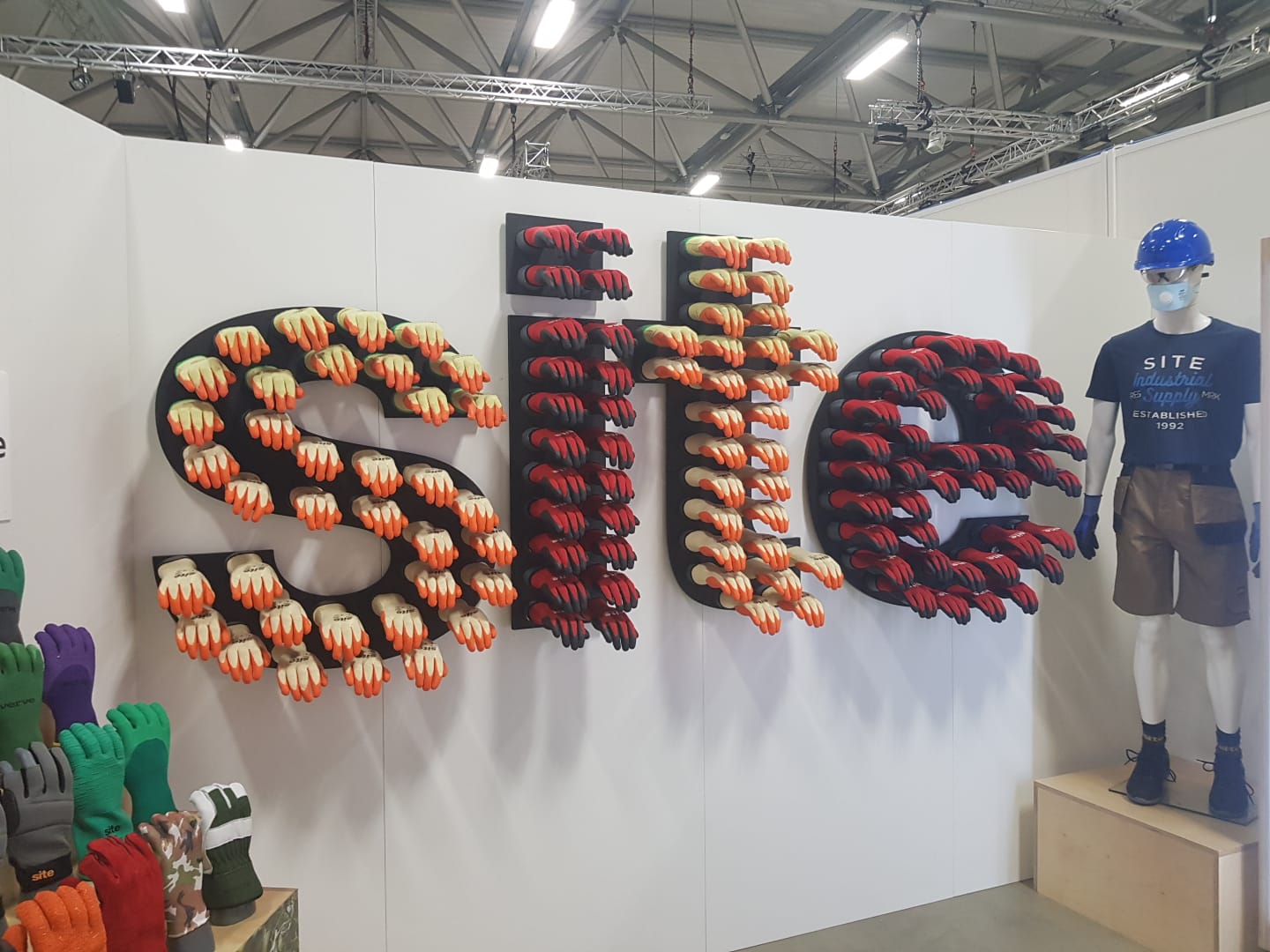 A mannequin is standing in front of a sign that says site