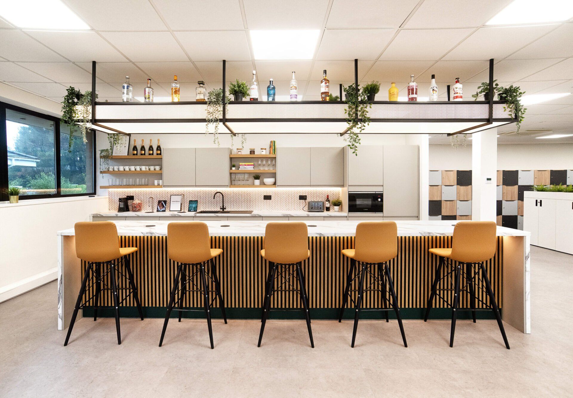 A kitchen with a long counter and stools