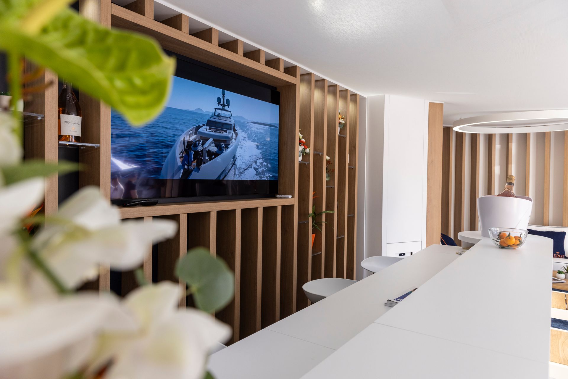 A living room with a large flat screen tv on the wall.