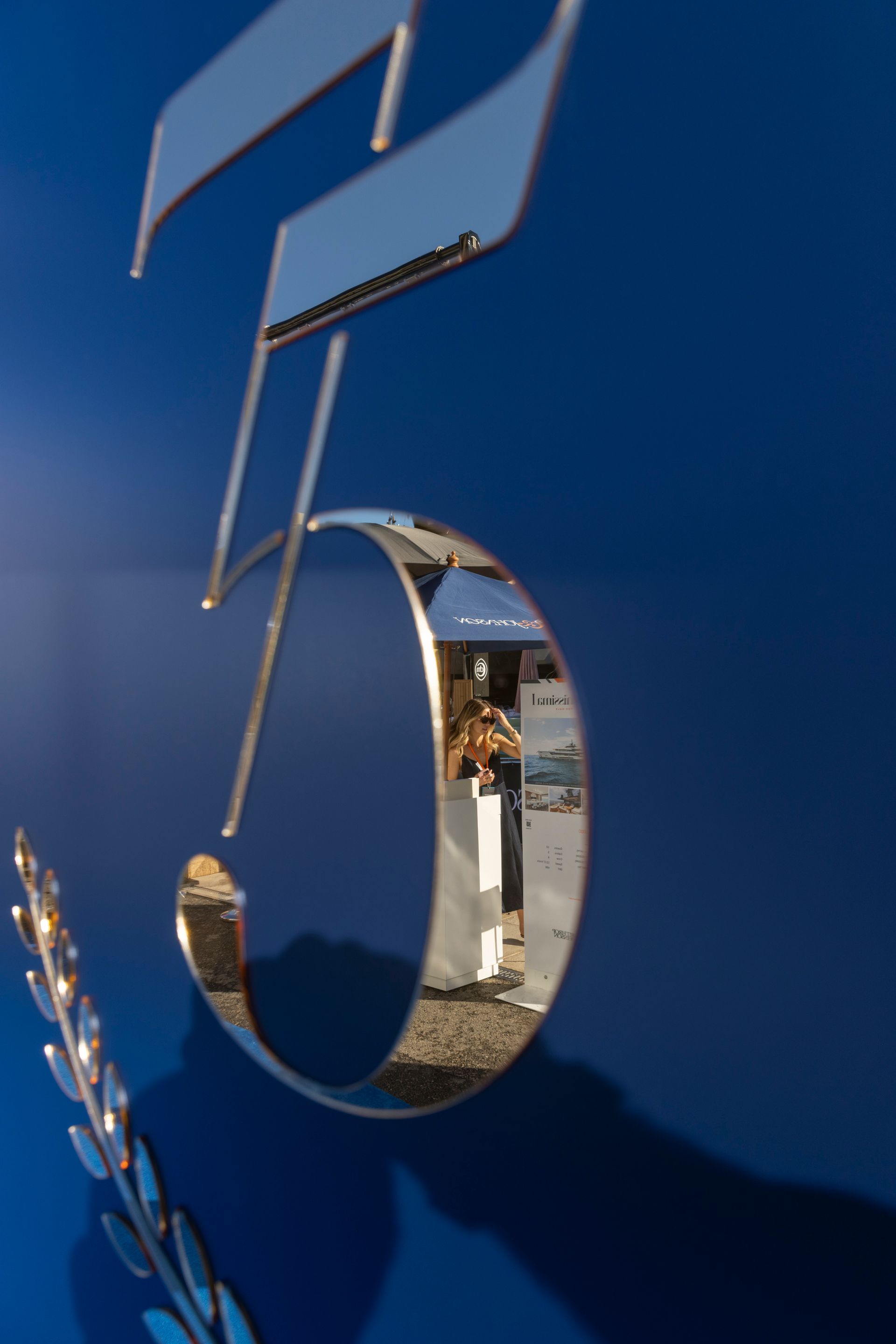 A reflection of a person playing a violin in the number 5