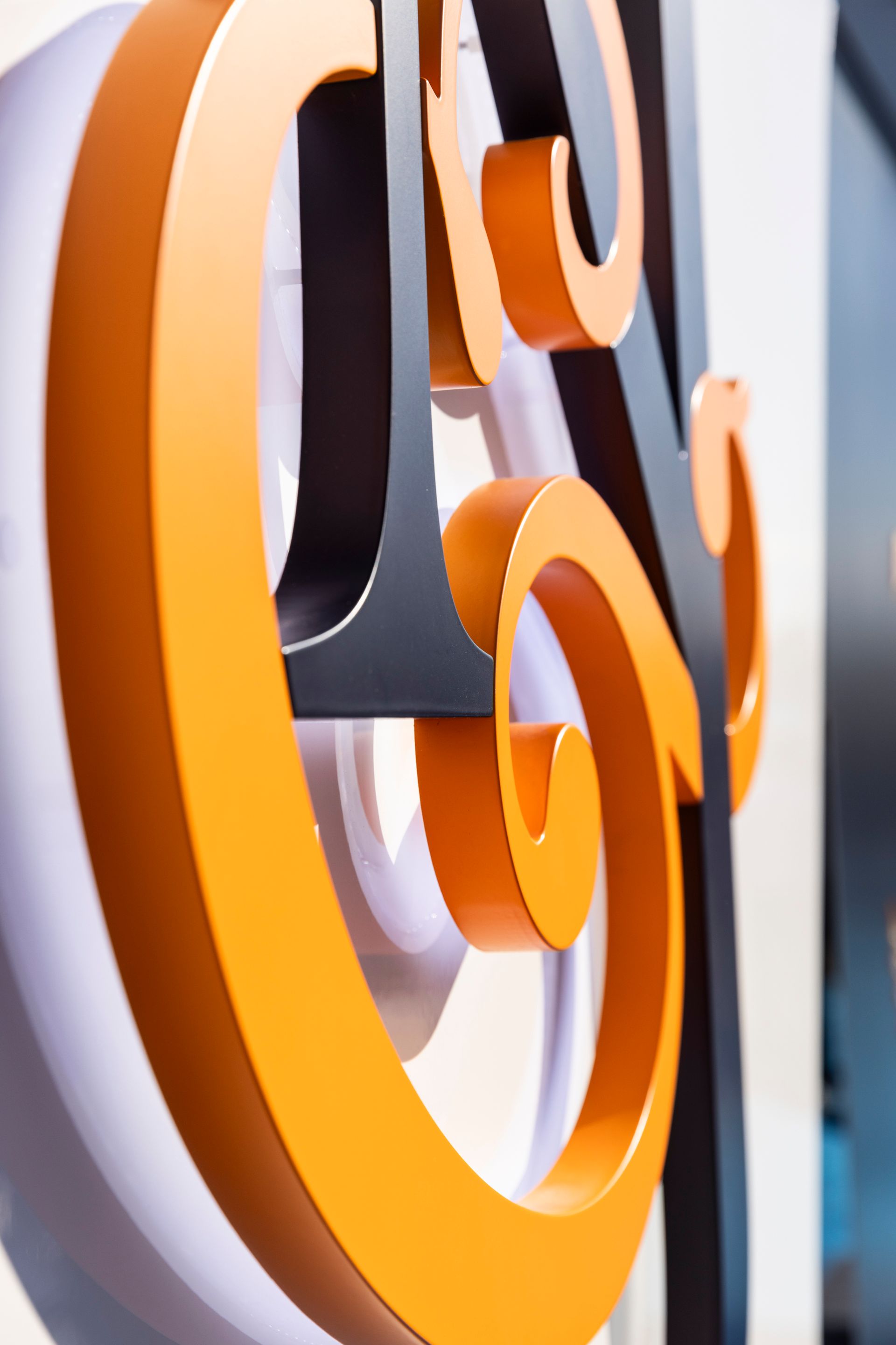 A close up of an orange and black letter g