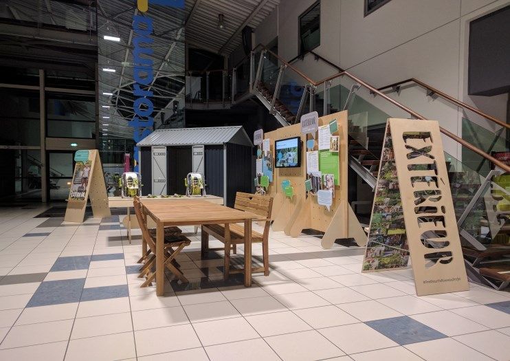 A room with a table and chairs and a sign that says exterior