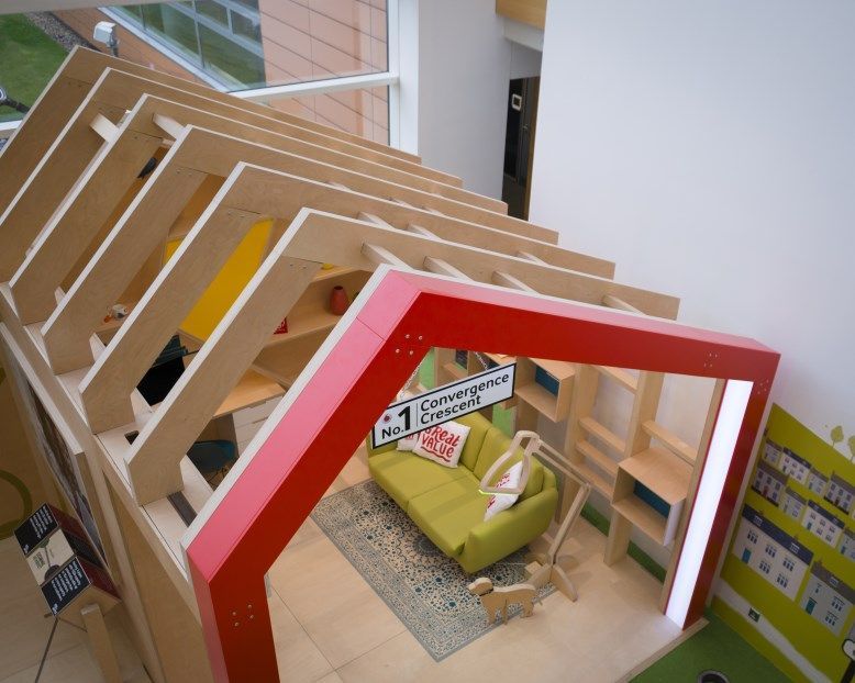 A wooden house with a green couch and a sign that says no. 1