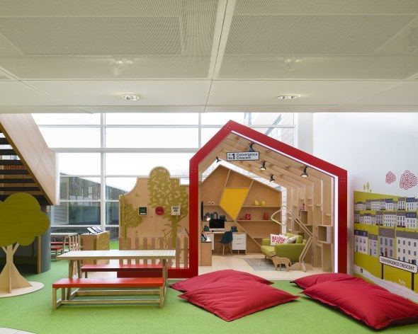 A room with a red house in the middle of it