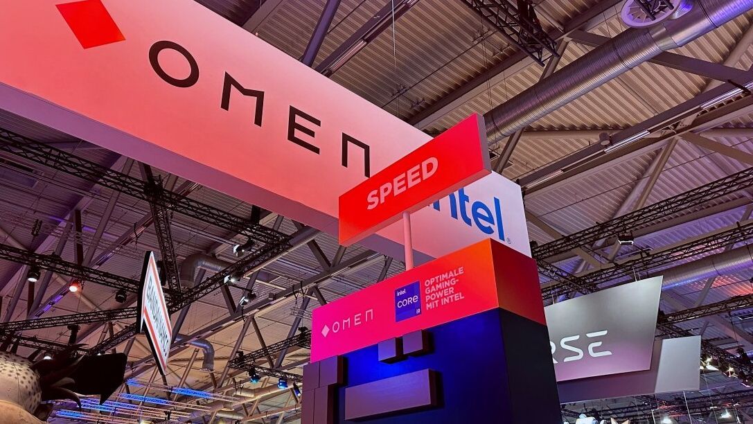 A sign that says omen speed is hanging from the ceiling of a building.