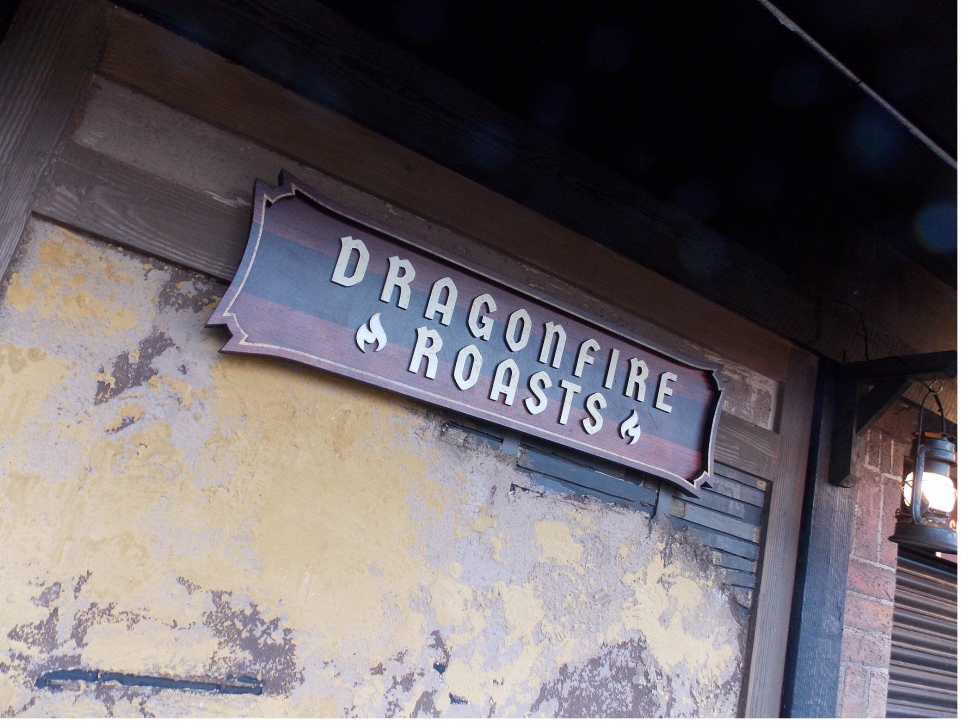 A sign on a building that says dragonfire roasts 4