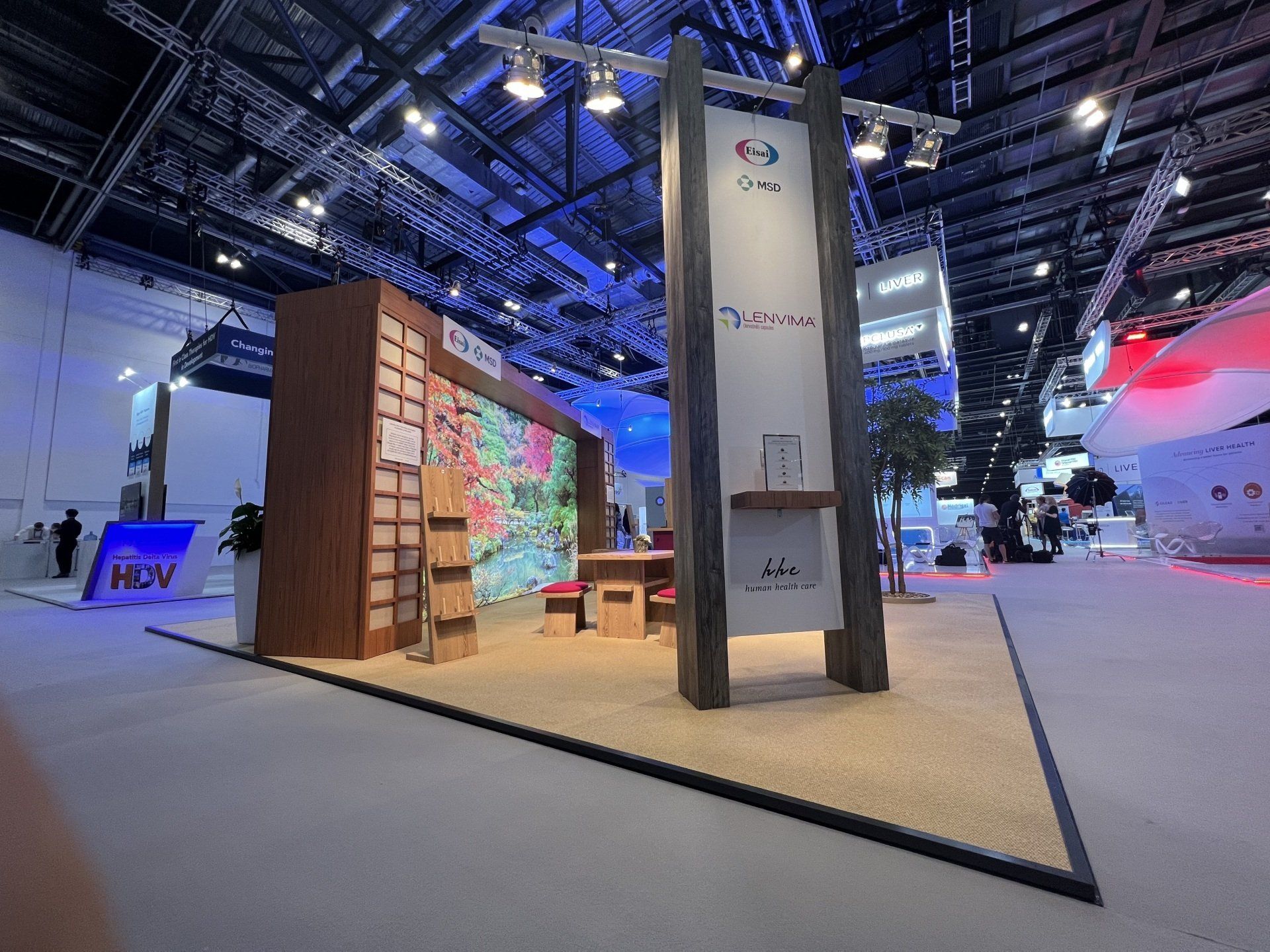 A large room with a display booth in the middle of it.