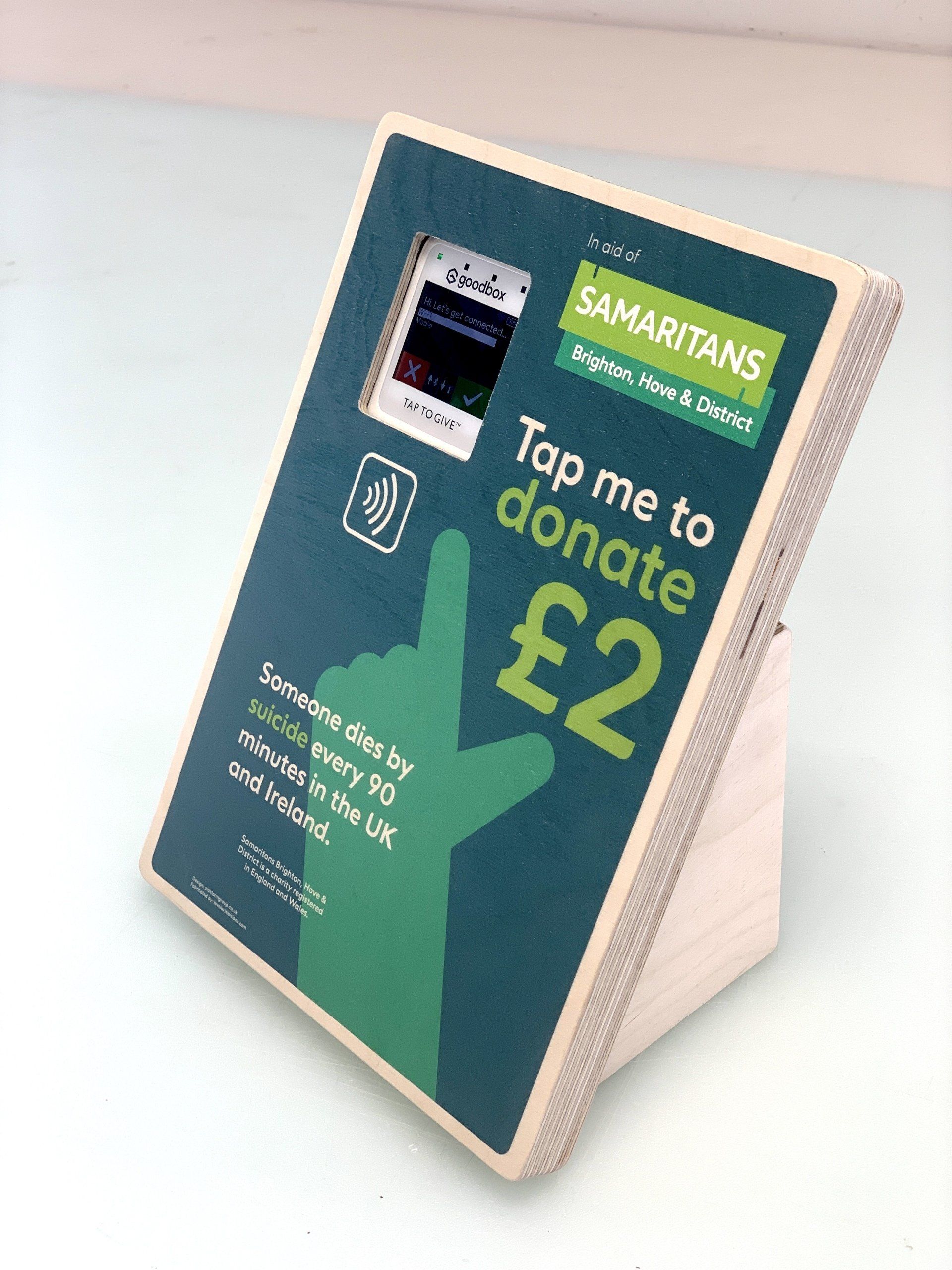 A sign that says tap me to donate £ 2