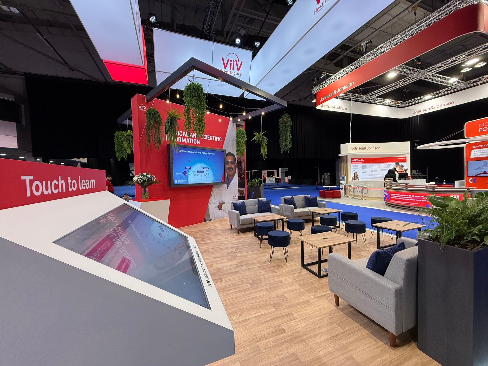 A large room with a lot of furniture and a large screen.