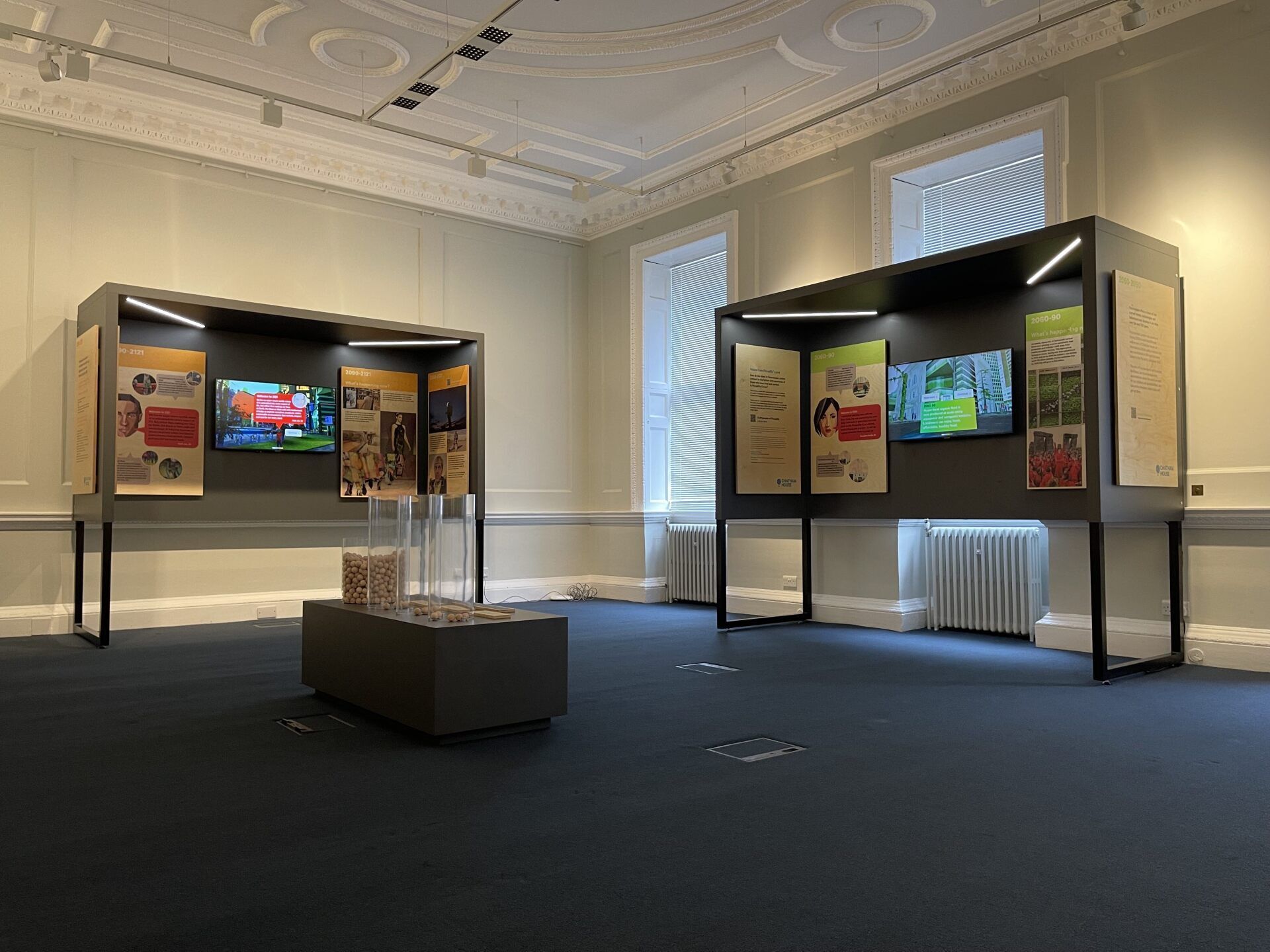 A large room with a lot of artwork on the walls and a table in the middle of the room.