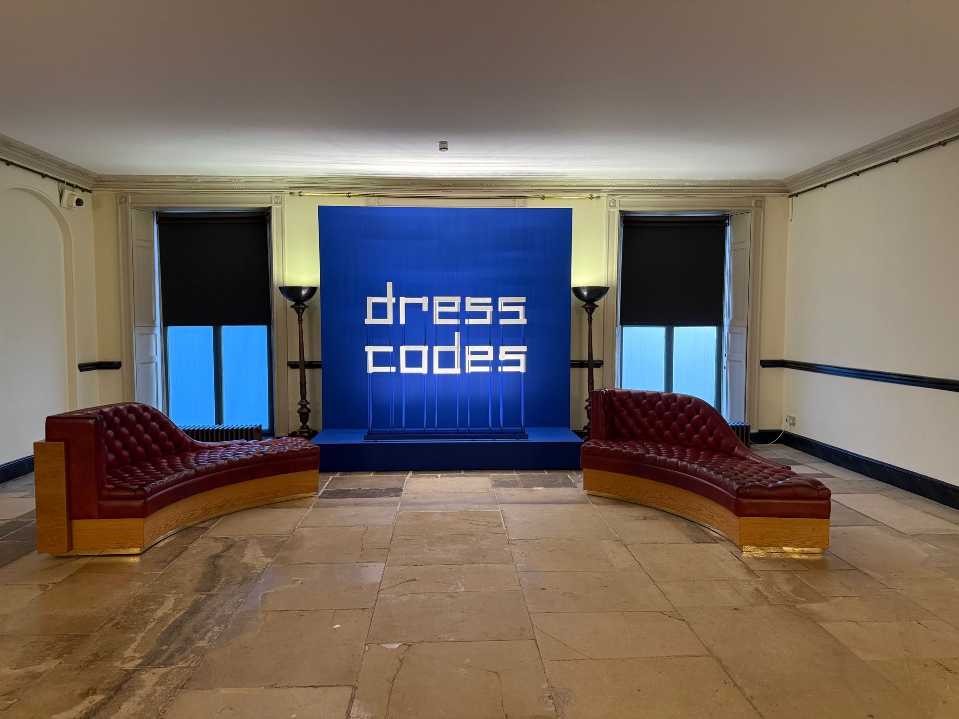 A room with a couch and a sign that says dress codes