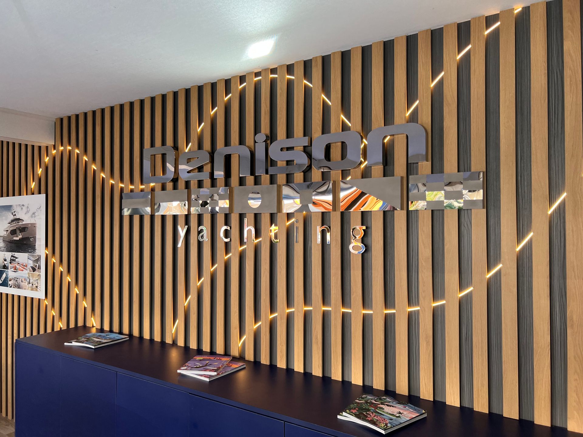 A wooden wall with a sign that says denison yachting