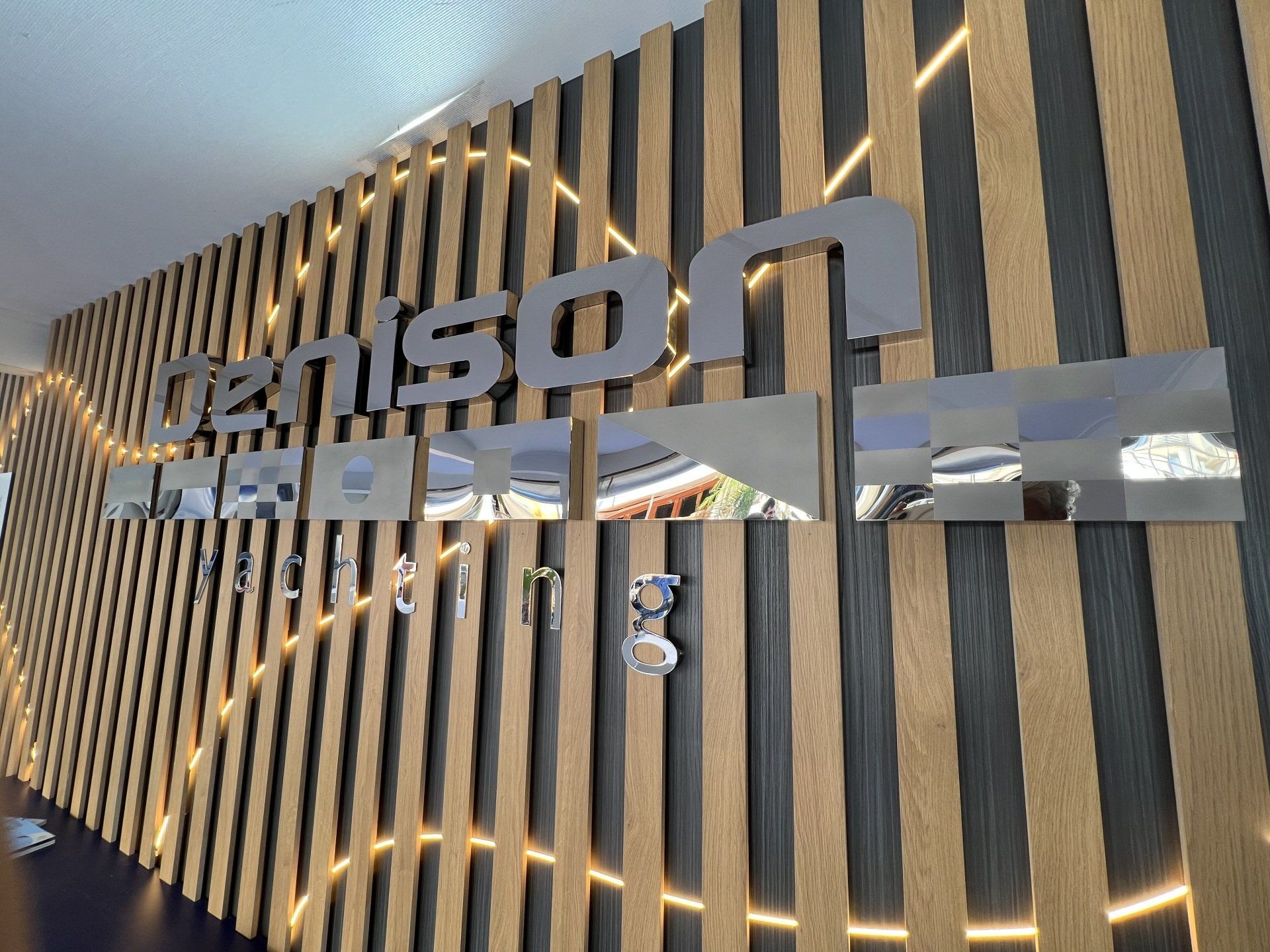 A wooden wall with a sign that says ' denson ' on it