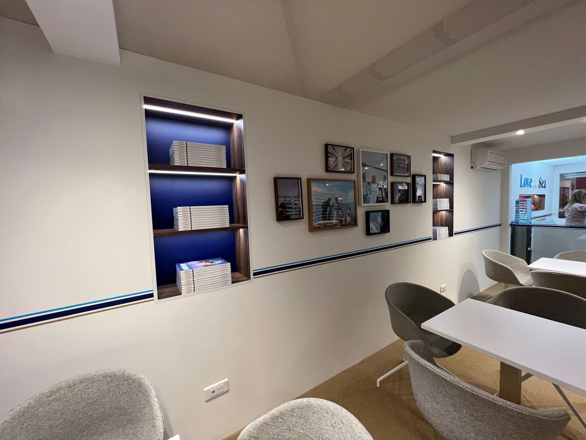 A room with a table and chairs and pictures on the wall
