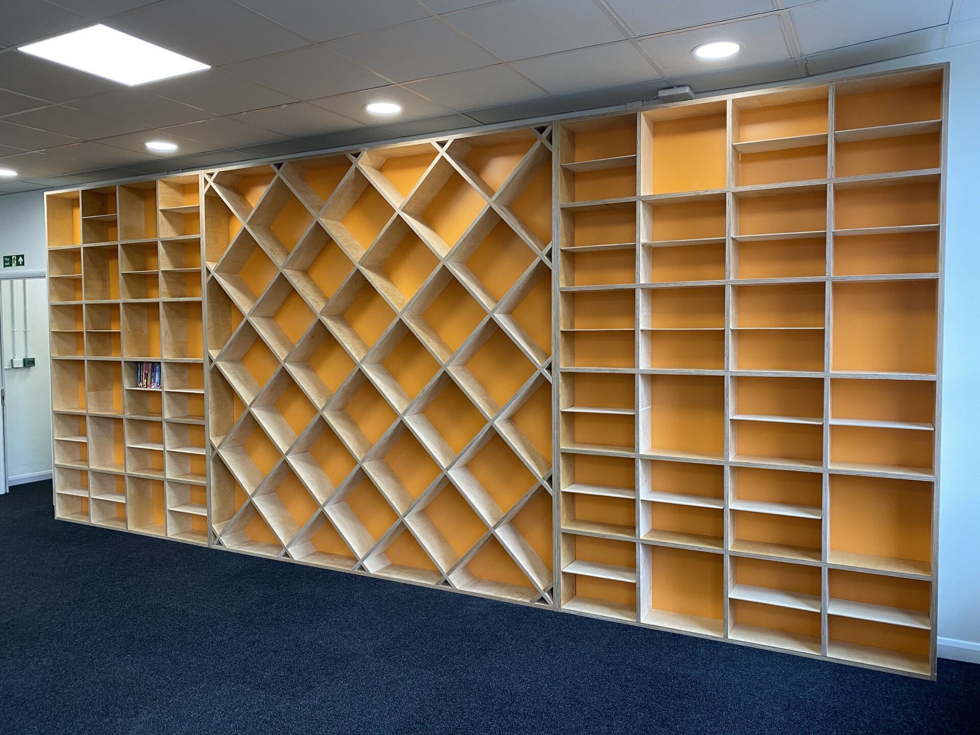 A wall filled with lots of shelves in a room